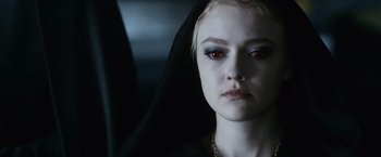 Movie still from “The Twilight Saga: Eclipse” (2010), directed by David Slade – A woman with red eyes and a black head covering; Close Up shot, Over the shoulder angle