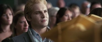 Movie still from “The Twilight Saga: Eclipse” (2010), directed by David Slade – A person sitting in front of a crowd; Close Up shot, Over the shoulder angle