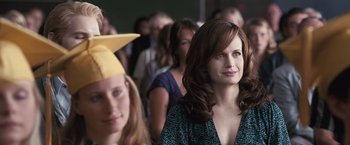 Movie still from “The Twilight Saga: Eclipse” (2010), directed by David Slade – A woman in a graduation cap and a girl in a yellow hat; Close Up shot, Over the shoulder angle