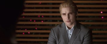 Movie still from “The Twilight Saga: Eclipse” (2010), directed by David Slade – A man wearing a suit and tie in front of a window; Close Up shot, Over the shoulder angle