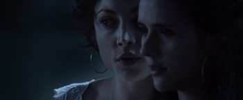 Movie still from “The Twilight Saga: Eclipse” (2010), directed by David Slade – A woman is looking at the camera with a reflection of herself in the mirror; Close Up shot, Over the shoulder angle