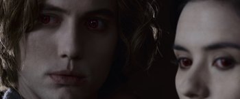Movie still from “The Twilight Saga: Eclipse” (2010), directed by David Slade – A person with a red eye; Close Up shot, Over the shoulder angle