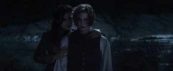 Movie still from “The Twilight Saga: Eclipse” (2010), directed by David Slade – A man and a woman standing next to each other in the dark; Medium shot, High angle