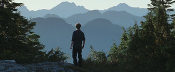 Movie still from “The Twilight Saga: Eclipse” (2010), directed by David Slade – A man standing on top of a hill looking at the mountains; Extreme Wide shot, Low angle