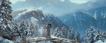 Movie still from “The Twilight Saga: Eclipse” (2010), directed by David Slade – A man and a woman standing on top of a snow covered hill; Wide shot, Low angle