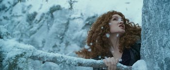 Movie still from “The Twilight Saga: Eclipse” (2010), directed by David Slade – A woman with curly red hair leaning up against a railing in the snow; Close Up shot, Low angle