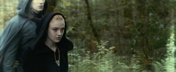 Movie still from “The Twilight Saga: Eclipse” (2010), directed by David Slade – A woman in a black hoodie standing next to a body of water; Close Up shot, Over the shoulder angle