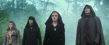 Movie still from “The Twilight Saga: Eclipse” (2010), directed by David Slade – A woman in a black outfit with a hood over her head; Medium shot, Low angle