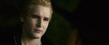 Movie still from “The Twilight Saga: Eclipse” (2010), directed by David Slade – A young man with blonde hair and blue eyes stares into the camera; Close Up shot, Over the shoulder angle