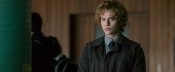 Movie still from “The Twilight Saga: New Moon” (2009), directed by Chris Weitz – A man with a curly hair and a blue tie; Close Up shot, Over the shoulder angle