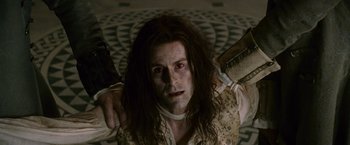 Movie still from “The Twilight Saga: New Moon” (2009), directed by Chris Weitz – A man with long black hair holding a knife; Medium shot, High angle