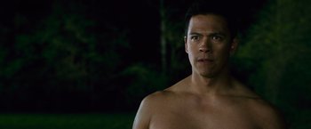 Movie still from “The Twilight Saga: New Moon” (2009), directed by Chris Weitz – A man with no shirt standing in the dark; Close Up shot, Over the shoulder angle