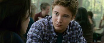 Movie still from “The Twilight Saga: New Moon” (2009), directed by Chris Weitz – A young man in a plaid shirt looking at the camera; Close Up shot, Over the shoulder angle