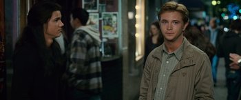Movie still from “The Twilight Saga: New Moon” (2009), directed by Chris Weitz – A young man standing in front of other people; Medium shot, Over the shoulder angle