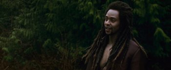 Movie still from “The Twilight Saga: New Moon” (2009), directed by Chris Weitz – A man with dreads standing in front of a tree; Close Up shot, Over the shoulder angle