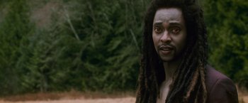 Movie still from “The Twilight Saga: New Moon” (2009), directed by Chris Weitz – A person with dreadlocks looking at the camera; Close Up shot, Over the shoulder angle