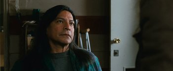 Movie still from “The Twilight Saga: New Moon” (2009), directed by Chris Weitz – A man with long black hair standing in front of a door; Close Up shot, Low angle