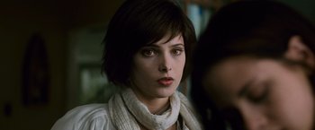 Movie still from “The Twilight Saga: New Moon” (2009), directed by Chris Weitz – A person with short hair wearing a scarf; Close Up shot, Over the shoulder angle