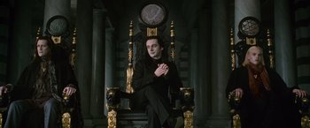 Movie still from “The Twilight Saga: New Moon” (2009), directed by Chris Weitz – A man sitting on a throne in front of a clock; Medium shot, High angle