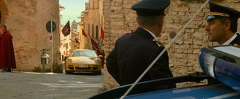 Movie still from “The Twilight Saga: New Moon” (2009), directed by Chris Weitz – A police officer standing in front of a yellow car; Wide shot, Over the shoulder angle