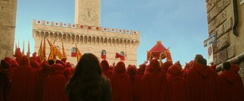 Movie still from “The Twilight Saga: New Moon” (2009), directed by Chris Weitz – A group of people in red robes standing in front of a building; Extreme Wide shot, Low angle
