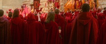 Movie still from “The Twilight Saga: New Moon” (2009), directed by Chris Weitz – A group of people wearing red robes and holding flags; Wide shot, High angle