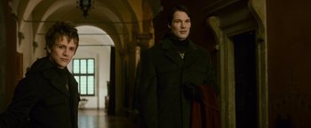 Movie still from “The Twilight Saga: New Moon” (2009), directed by Chris Weitz – A man wearing a black coat and a red scarf; Medium shot, Low angle