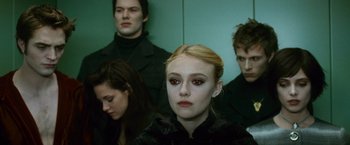Movie still from “The Twilight Saga: New Moon” (2009), directed by Chris Weitz – A group of people standing next to each other in a room; Close Up shot, Over the shoulder angle