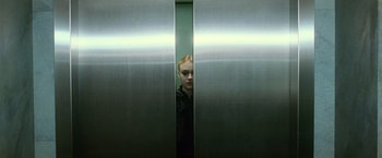 Movie still from “The Twilight Saga: New Moon” (2009), directed by Chris Weitz – A woman standing in an elevator with her head in the door; Close Up shot, Low angle