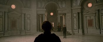 Movie still from “The Twilight Saga: New Moon” (2009), directed by Chris Weitz – A man standing in front of a group of people in front of a building; Wide shot, High angle