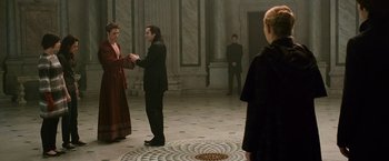 Movie still from “The Twilight Saga: New Moon” (2009), directed by Chris Weitz – A group of people standing around in a room; Wide shot, Over the shoulder angle