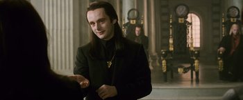 Movie still from “The Twilight Saga: New Moon” (2009), directed by Chris Weitz – A man with long black hair wearing a black suit; Close Up shot, Over the shoulder angle