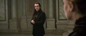 Movie still from “The Twilight Saga: New Moon” (2009), directed by Chris Weitz – A man in a black suit standing in front of a building; Medium shot, Over the shoulder angle