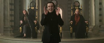 Movie still from “The Twilight Saga: New Moon” (2009), directed by Chris Weitz – A man in a black suit is clapping his hands; Medium shot, Low angle
