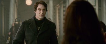 Movie still from “The Twilight Saga: New Moon” (2009), directed by Chris Weitz – A man standing in front of a mirror looking at a woman; Close Up shot, Over the shoulder angle