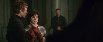 Movie still from “The Twilight Saga: New Moon” (2009), directed by Chris Weitz – A woman wearing red gloves and a man in a black jacket; Medium shot, Over the shoulder angle