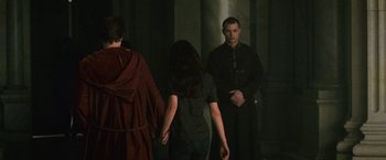 Movie still from “The Twilight Saga: New Moon” (2009), directed by Chris Weitz – A group of people standing in front of a pillar; Medium shot, Over the shoulder angle