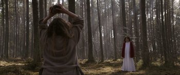 Movie still from “The Twin” (2022), directed by Taneli Mustonen – A woman in a white dress standing next to another woman in a white dress; Wide shot, Over the shoulder angle