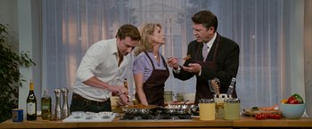 Movie still from “The Ugly Truth” (2009), directed by Robert Luketic – A group of people standing in front of a stove; Medium shot, High angle