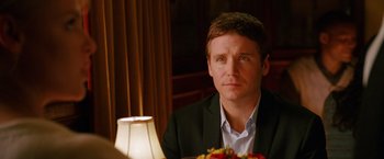 Movie still from “The Ugly Truth” (2009), directed by Robert Luketic – A person sitting at a table; Close Up shot, Over the shoulder angle