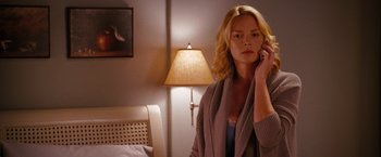 Movie still from “The Ugly Truth” (2009), directed by Robert Luketic – A woman is talking on a cell phone in a bedroom; Medium shot, Over the shoulder angle