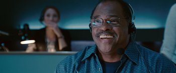 Movie still from “The Ugly Truth” (2009), directed by Robert Luketic – An older man with glasses is smiling for the camera; Close Up shot, Low angle