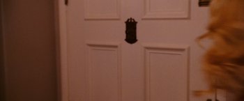 Movie still from “The Ugly Truth” (2009), directed by Robert Luketic – A white door with a black door knob on it's side; Extreme Close Up shot, High angle