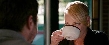 Movie still from “The Ugly Truth” (2009), directed by Robert Luketic – A woman is drinking from a white coffee cup; Close Up shot, Over the shoulder angle