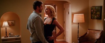 Movie still from “The Ugly Truth” (2009), directed by Robert Luketic – A man and a woman standing next to each other in a room; Medium shot, Over the shoulder angle