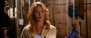 Movie still from “The Ugly Truth” (2009), directed by Robert Luketic – A woman with blonde wavy hair holding a clipboard; Close Up shot, Over the shoulder angle