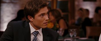 Movie still from “The Ugly Truth” (2009), directed by Robert Luketic – A man in a suit and tie looking to his left; Close Up shot, Over the shoulder angle