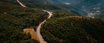 Movie still from “The Ugly Truth” (2009), directed by Robert Luketic – An aerial view of a curvy road in the mountains; Extreme Wide shot, High angle