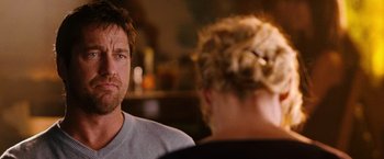 Movie still from “The Ugly Truth” (2009), directed by Robert Luketic – A man and a woman sitting at a table in front of each other; Close Up shot, Over the shoulder angle