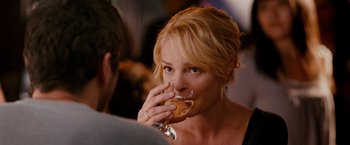 Movie still from “The Ugly Truth” (2009), directed by Robert Luketic – A woman drinking a glass of wine at a party; Close Up shot, Over the shoulder angle